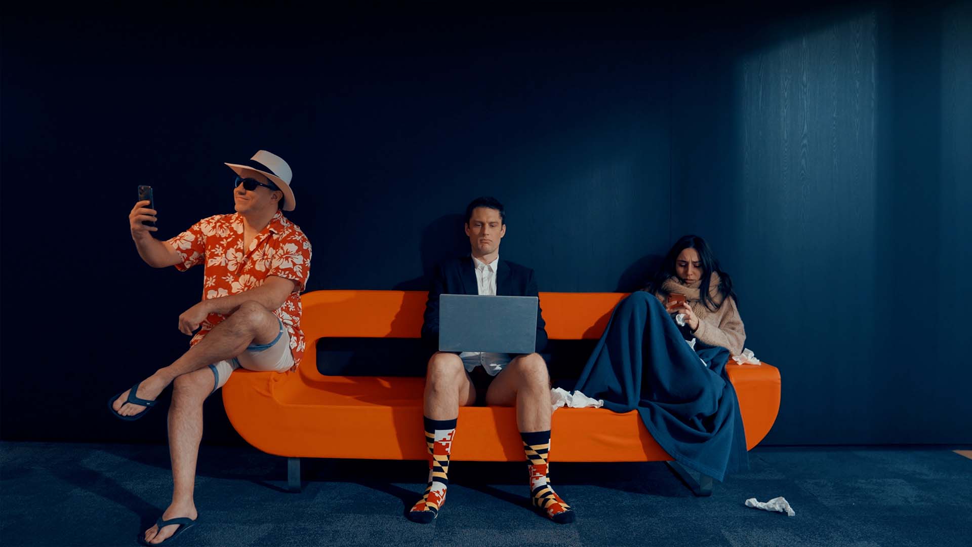 Trio burlesque sur canapé orange illustrant les absences RH dans ce film publicitaire pour Keeple, solution SaaS RH