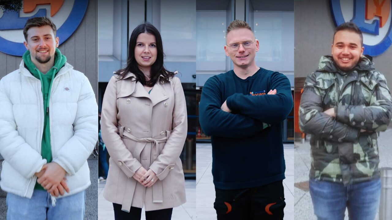 Quatre collaborateurs E. Leclerc souriants devant l'enseigne, film de recrutement grande distribution