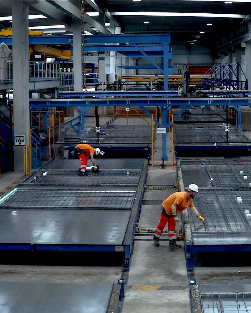 Ouvriers sur ligne de préfabrication béton en usine Rector Lesage, construction industrialisée — film institutionnel